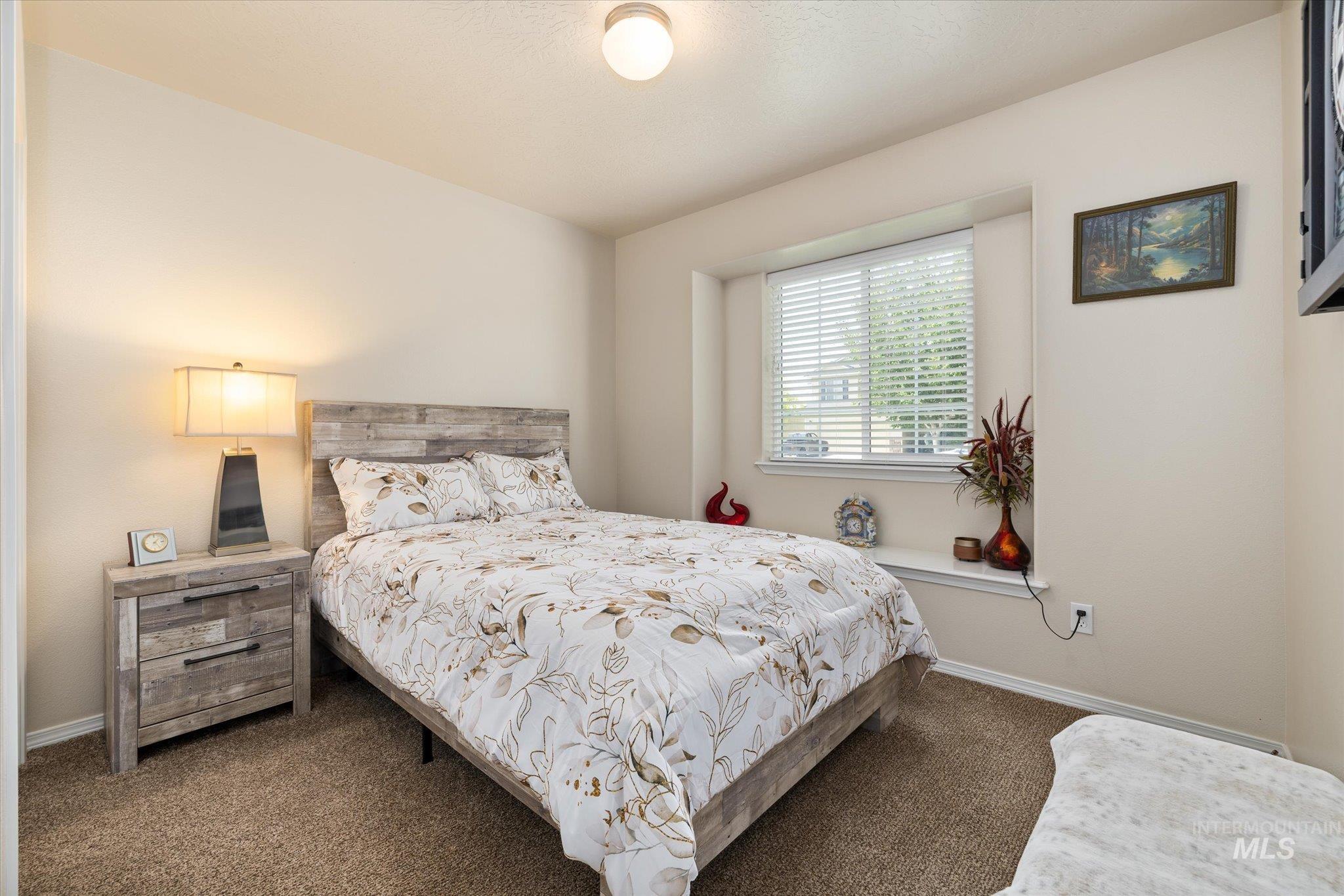 5401 Barkley Way Caldwell, ID 83607 - Photo 5 of 35 Carpeted room featuring a window with blinds, recessed ledge, and a ceiling light fixture