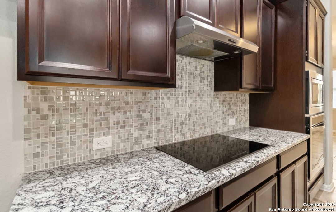 629 Cavan Cibolo, TX 78108 - Photo 11 of 20 a kitchen with granite countertop a sink a stove and cabinets