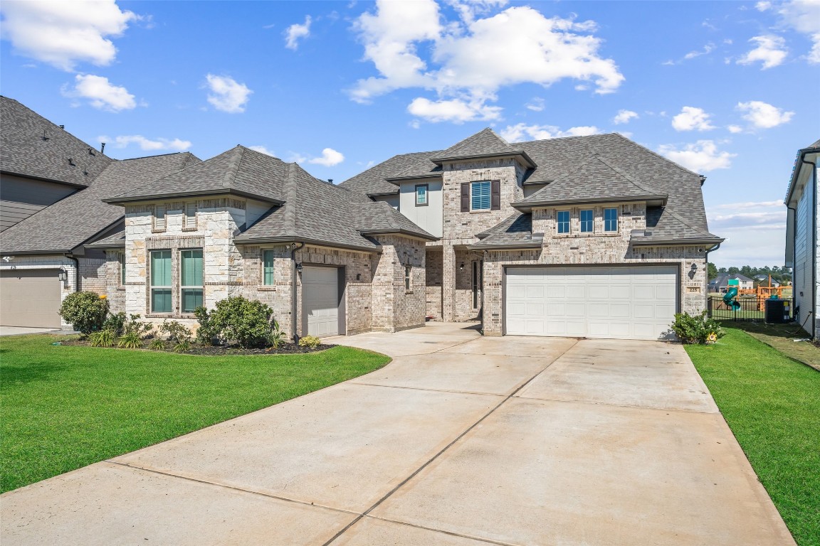 225 Peninsula Point Drive Montgomery, TX 77356 - Photo 1 of 38 a front view of a house with a garden and yard