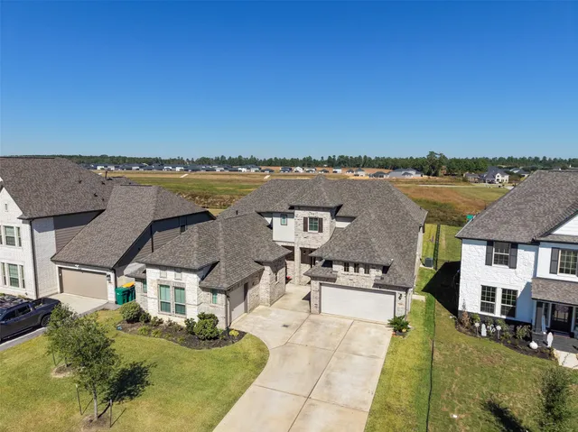 an aerial view of a house with a yard