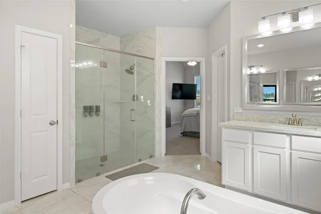 a spacious bathroom with a granite countertop sink mirror and shower