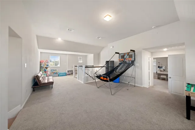 a living room with furniture and a gym equipment