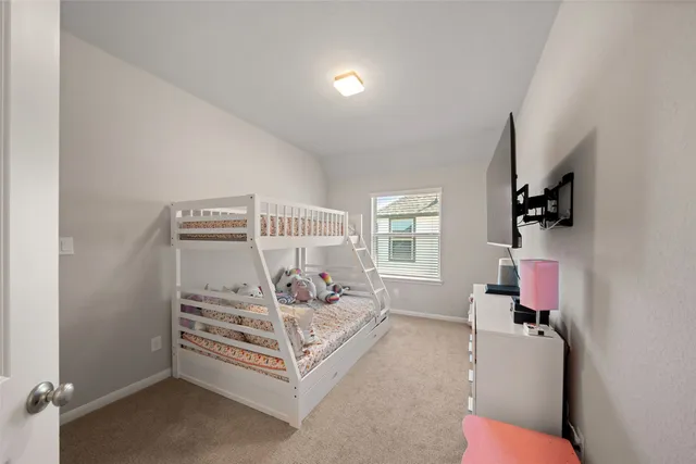 a bed room with furniture and a flat screen tv