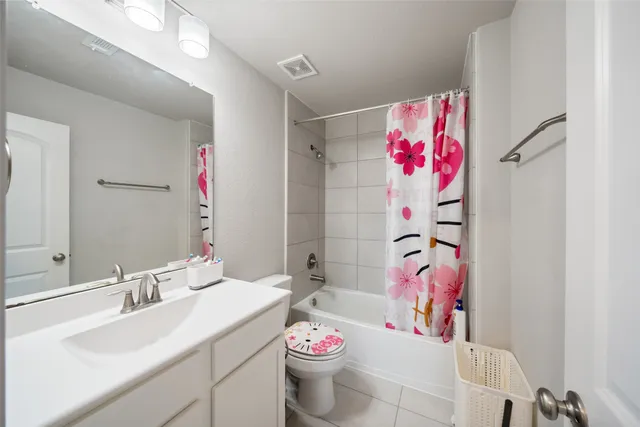 a bathroom with a sink vanity mirror and toilet