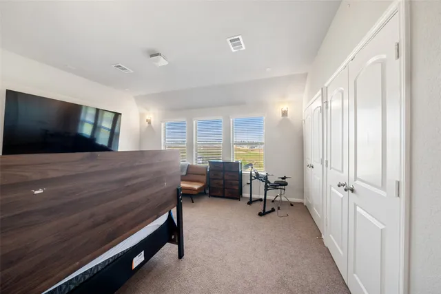 a bedroom with furniture and a flat screen tv