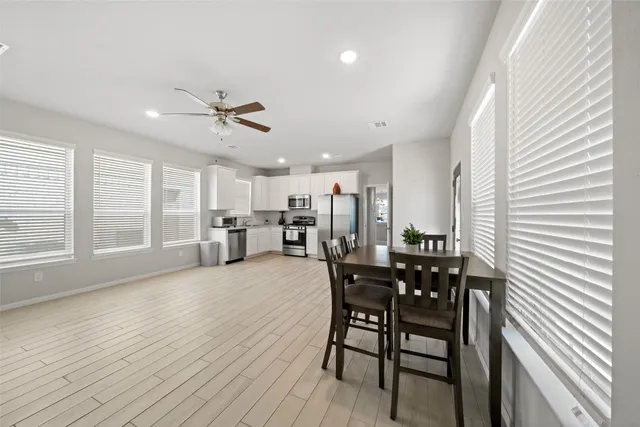a view of a dining room with furniture and a chandelier
