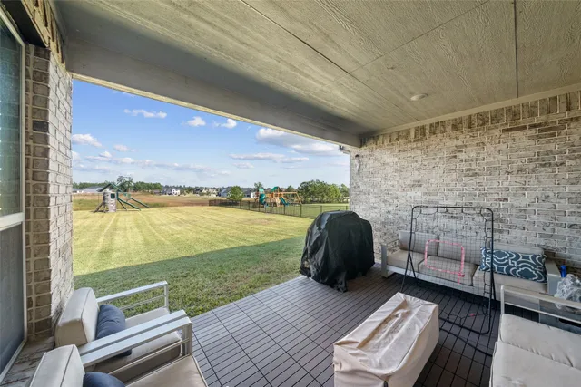 a view of a balcony with floor to ceiling window with wooden floor