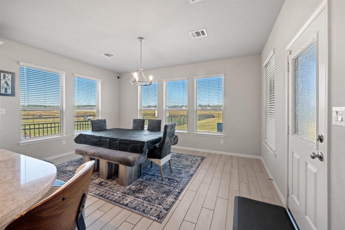 225 Peninsula Point Drive Montgomery, TX 77356 - Photo 8 of 38 a dining room with furniture and wooden floor