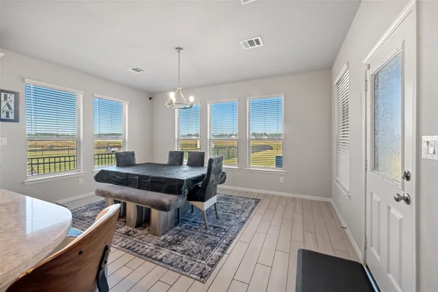 a dining room with furniture and wooden floor