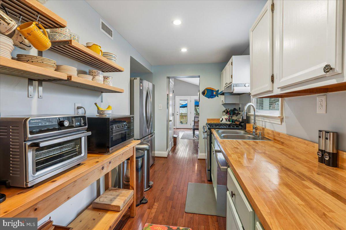 4801 Nicholson Street Riverdale, MD 20737 - Photo 14 of 39 a kitchen with stainless steel appliances a stove a refrigerator and wooden cabinets