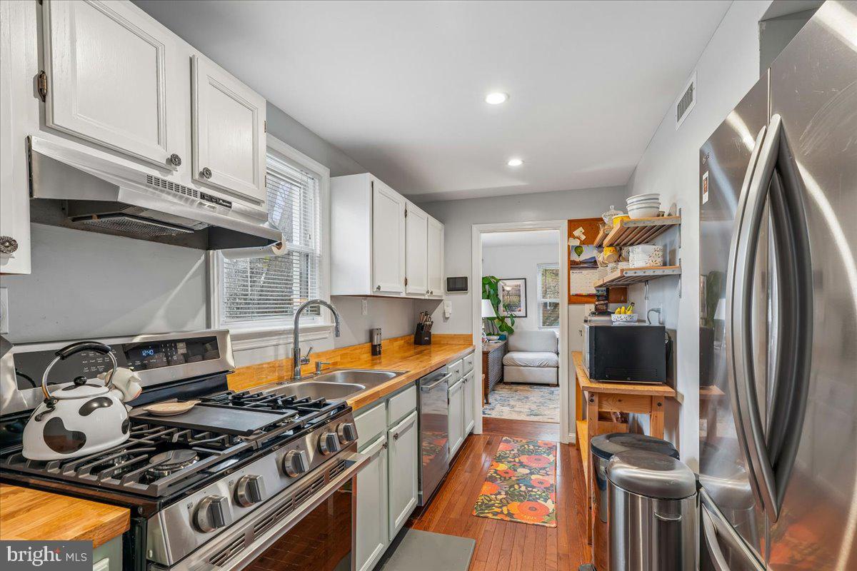 4801 Nicholson Street Riverdale, MD 20737 - Photo 17 of 39 a kitchen with stainless steel appliances granite countertop a stove and a refrigerator