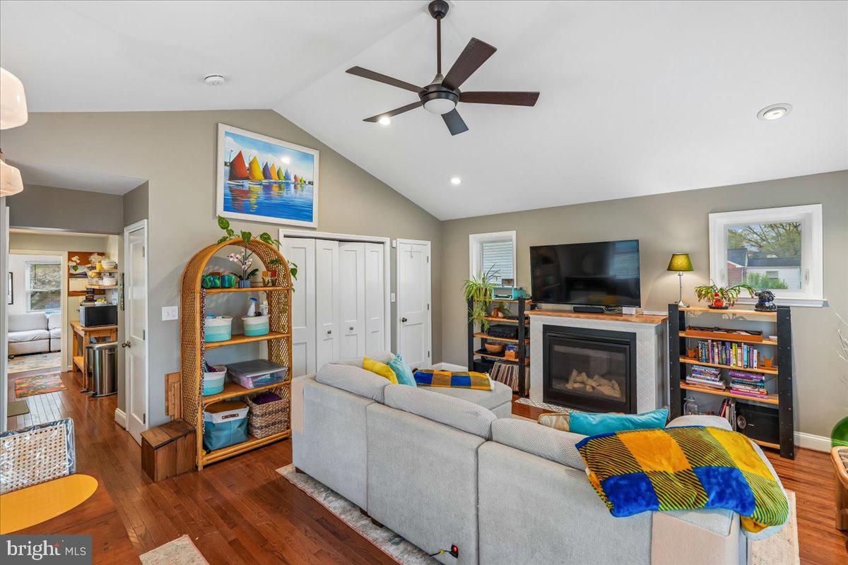 4801 Nicholson Street Riverdale, MD 20737 - Photo 20 of 39 a living room with furniture a flat screen tv and a fireplace