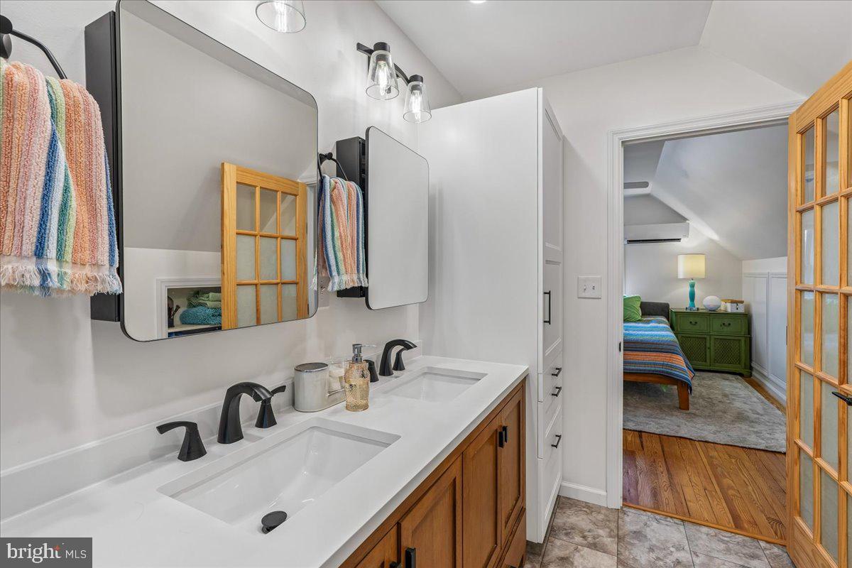 4801 Nicholson Street Riverdale, MD 20737 - Photo 26 of 39 a bathroom with a sink and a mirror