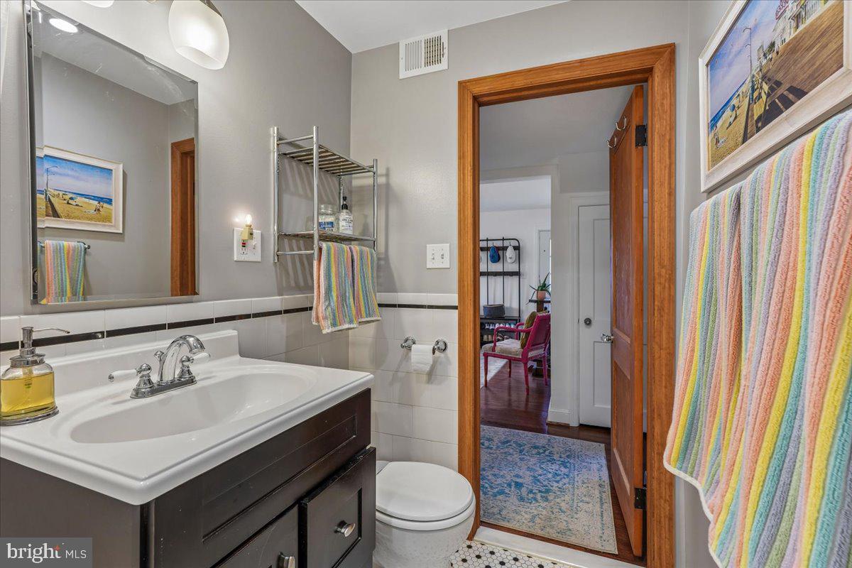 4801 Nicholson Street Riverdale, MD 20737 - Photo 31 of 39 a bathroom with a sink a toilet and shower