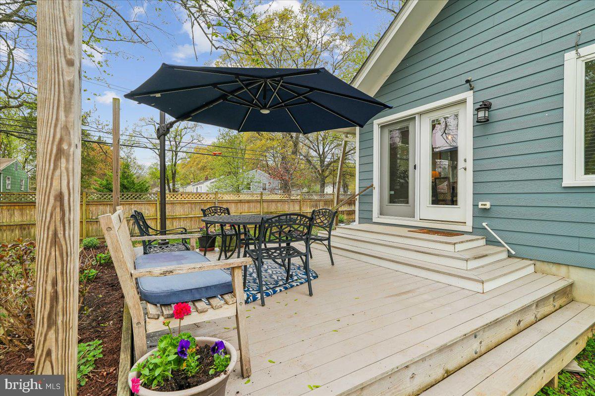 4801 Nicholson Street Riverdale, MD 20737 - Photo 4 of 39 a view of a patio with a table and chairs under an umbrella