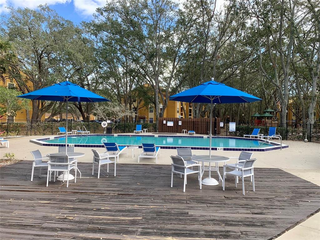 5263 Images Circle, Unit 106 Kissimmee, FL 34746 - Photo 14 of 17 a patio with a patio table and chairs