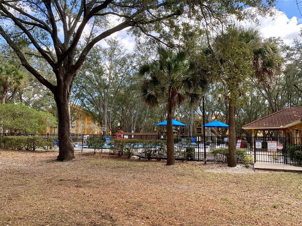 5263 Images Circle, Unit 106 Kissimmee, FL 34746 - Photo 15 of 17 a couple of people sitting in a yard in front of building
