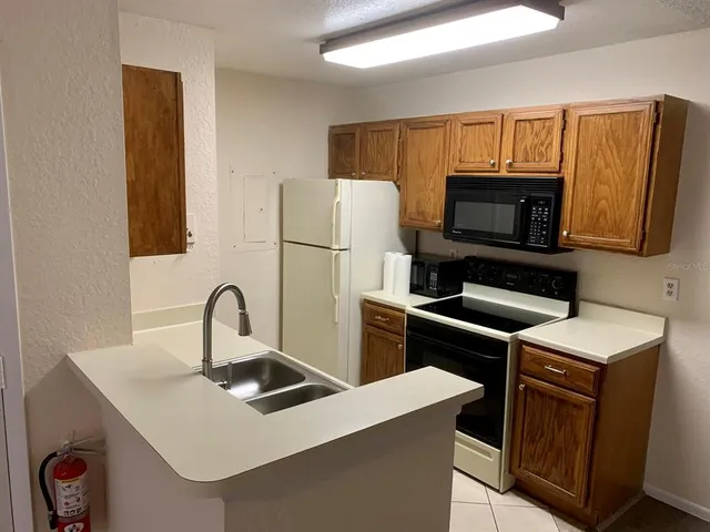 a kitchen with a stove a sink and a refrigerator