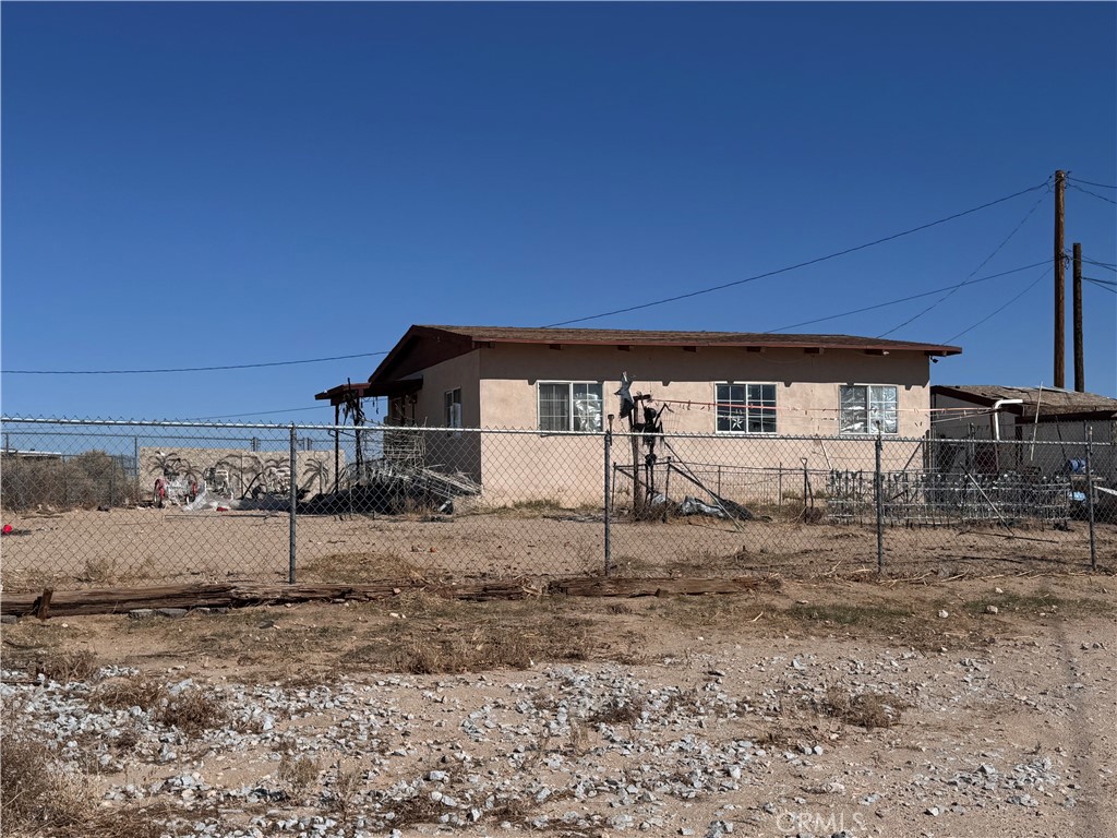 25617 Jasper Road Barstow, CA 92311 - Photo 2 of 6 a view of a house with a backyard