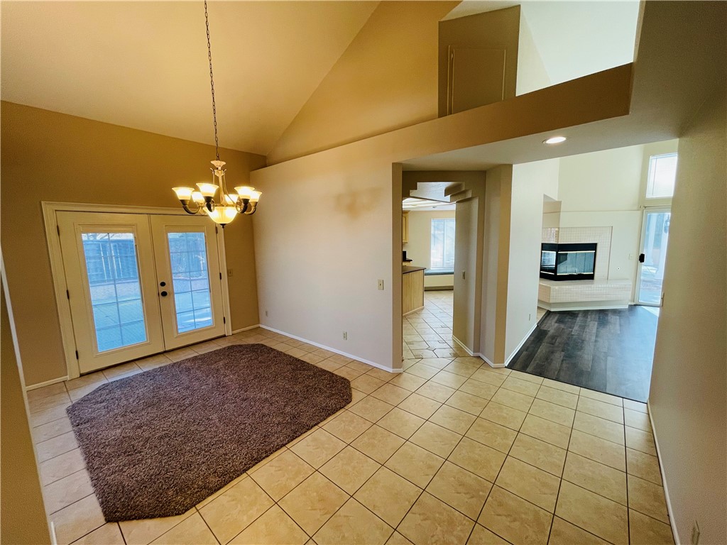 41915 Avenida Sonoma Temecula, CA 92591 - Photo 11 of 60 a view of a hallway with wooden floor and a chandelier