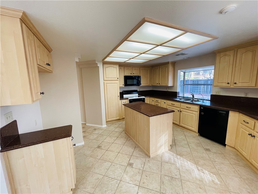 41915 Avenida Sonoma Temecula, CA 92591 - Photo 22 of 60 a kitchen with stainless steel appliances granite countertop a stove a sink a microwave and a refrigerator