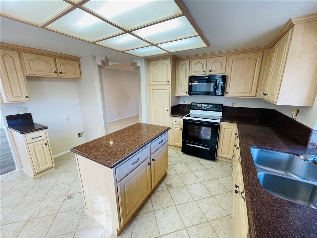 41915 Avenida Sonoma Temecula, CA 92591 - Photo 25 of 60 a kitchen with stainless steel appliances granite countertop a stove a sink and a microwave