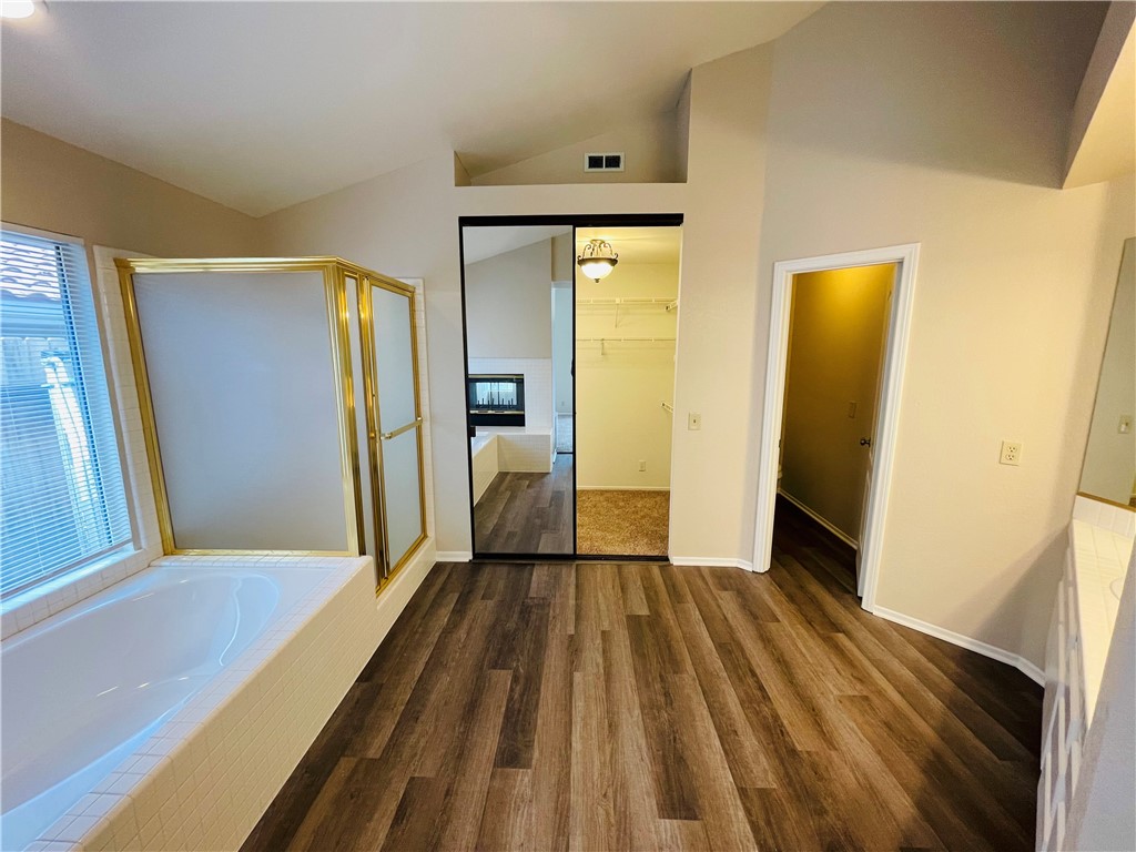 41915 Avenida Sonoma Temecula, CA 92591 - Photo 43 of 60 a view of a hallway with wooden floor and a bathroom