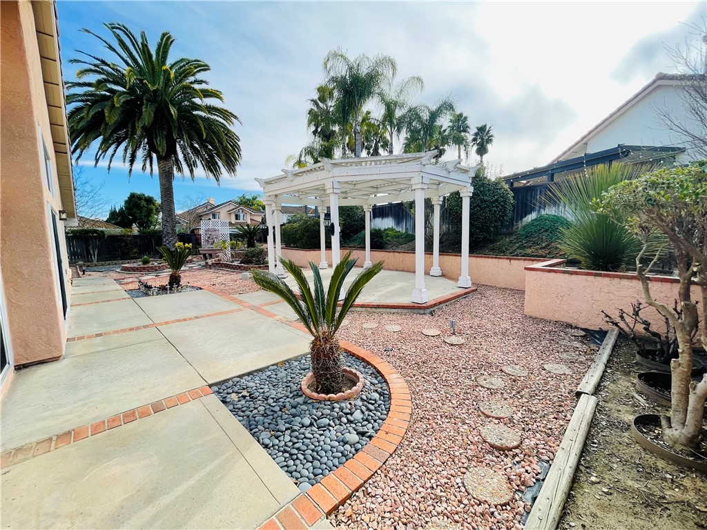 41915 Avenida Sonoma Temecula, CA 92591 - Photo 55 of 60 a front view of a house with garden and sitting area