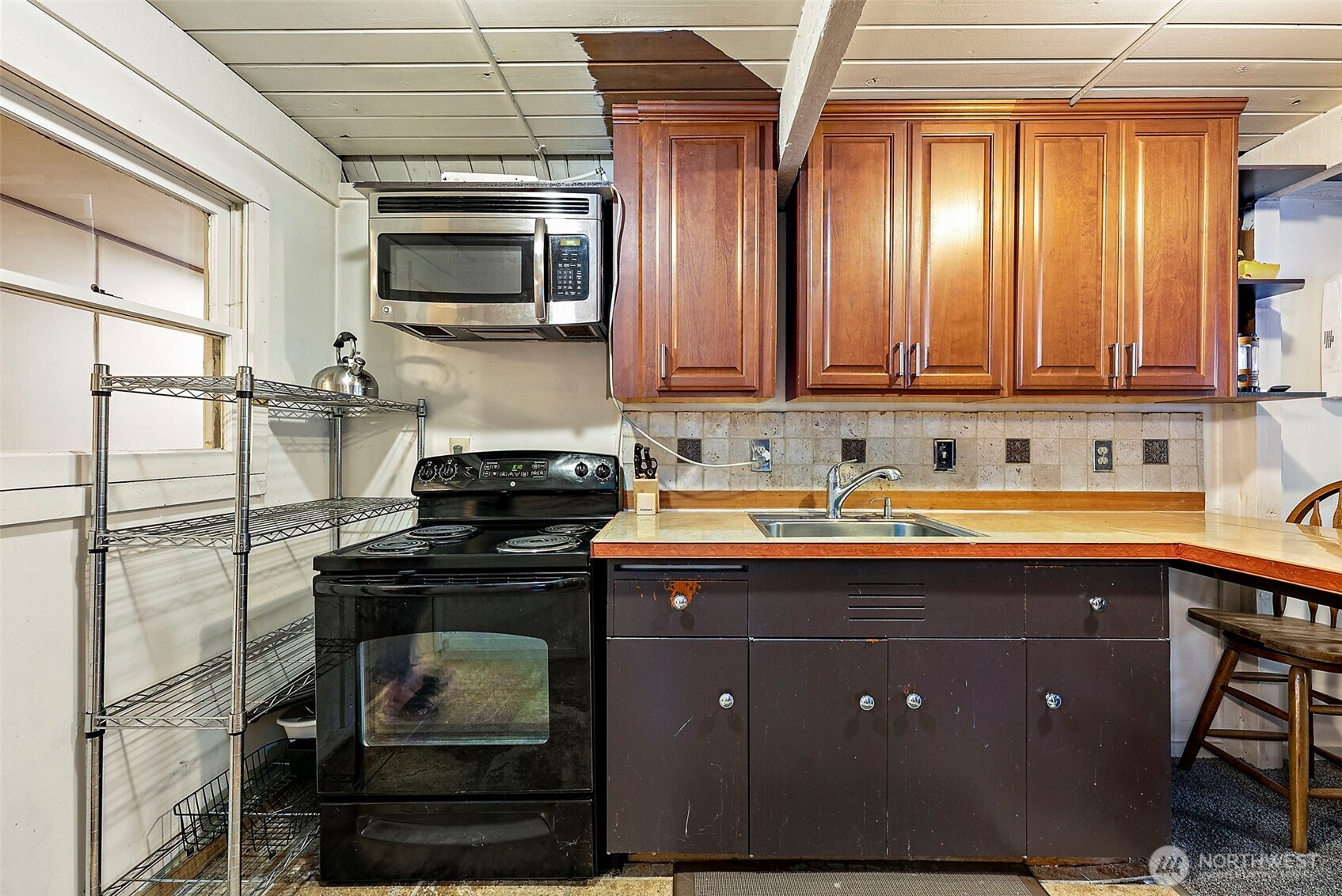 270 Skate Creek Road North Ashford, WA 98304 - Photo 12 of 36 a kitchen with stainless steel appliances granite countertop a stove a sink and a microwave