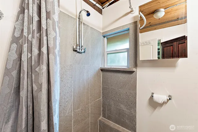 a bathroom with a shower and a sink