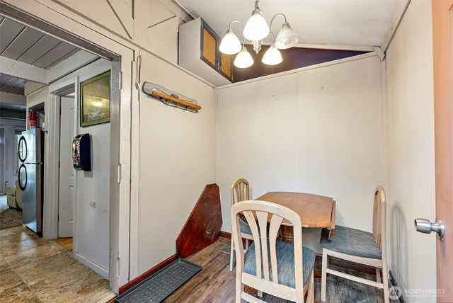 a view of a dining room with furniture and a chandelier