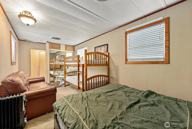 a bedroom with a bed couch and a window