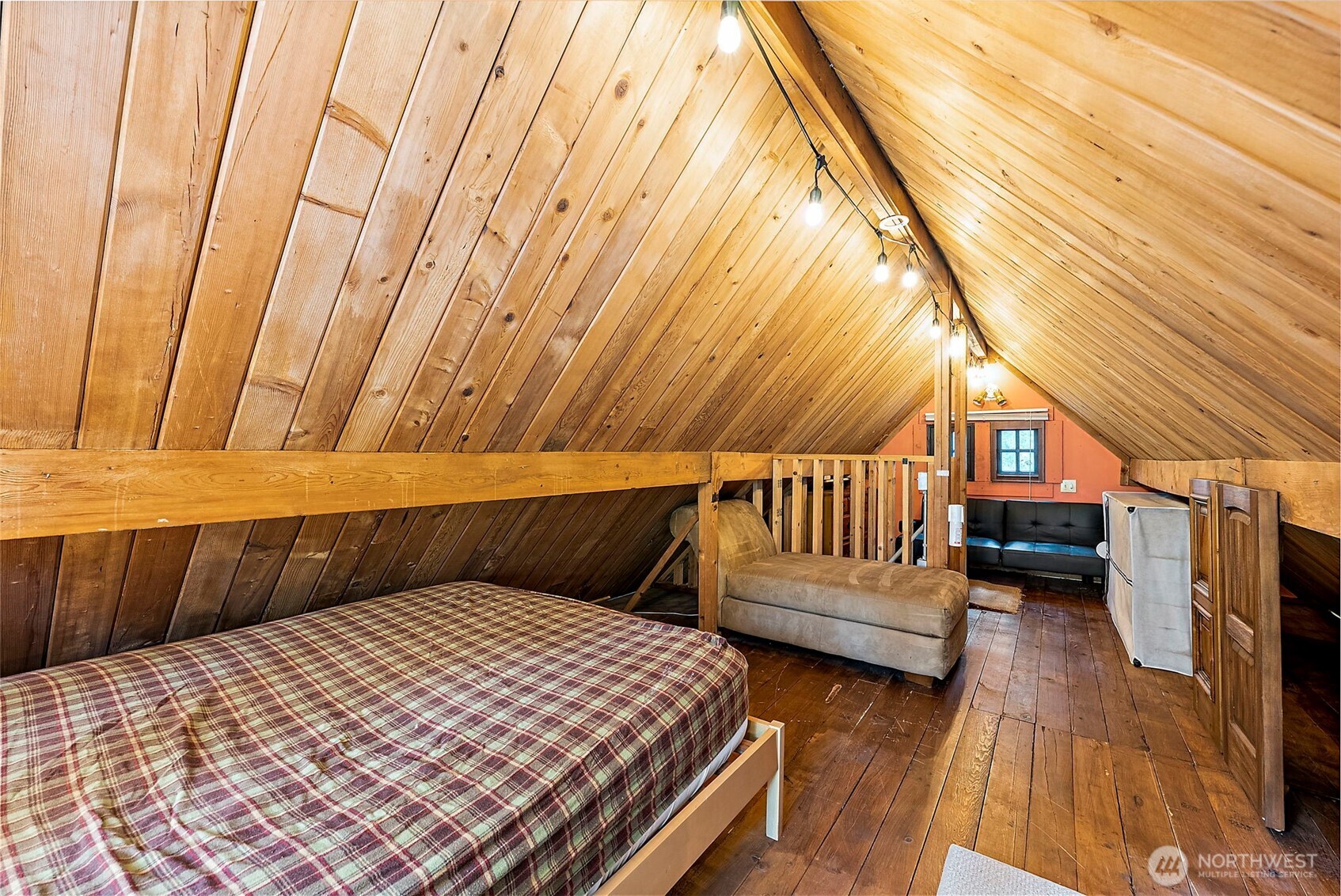 270 Skate Creek Road North Ashford, WA 98304 - Photo 20 of 36 a bedroom with a bed and wooden floor