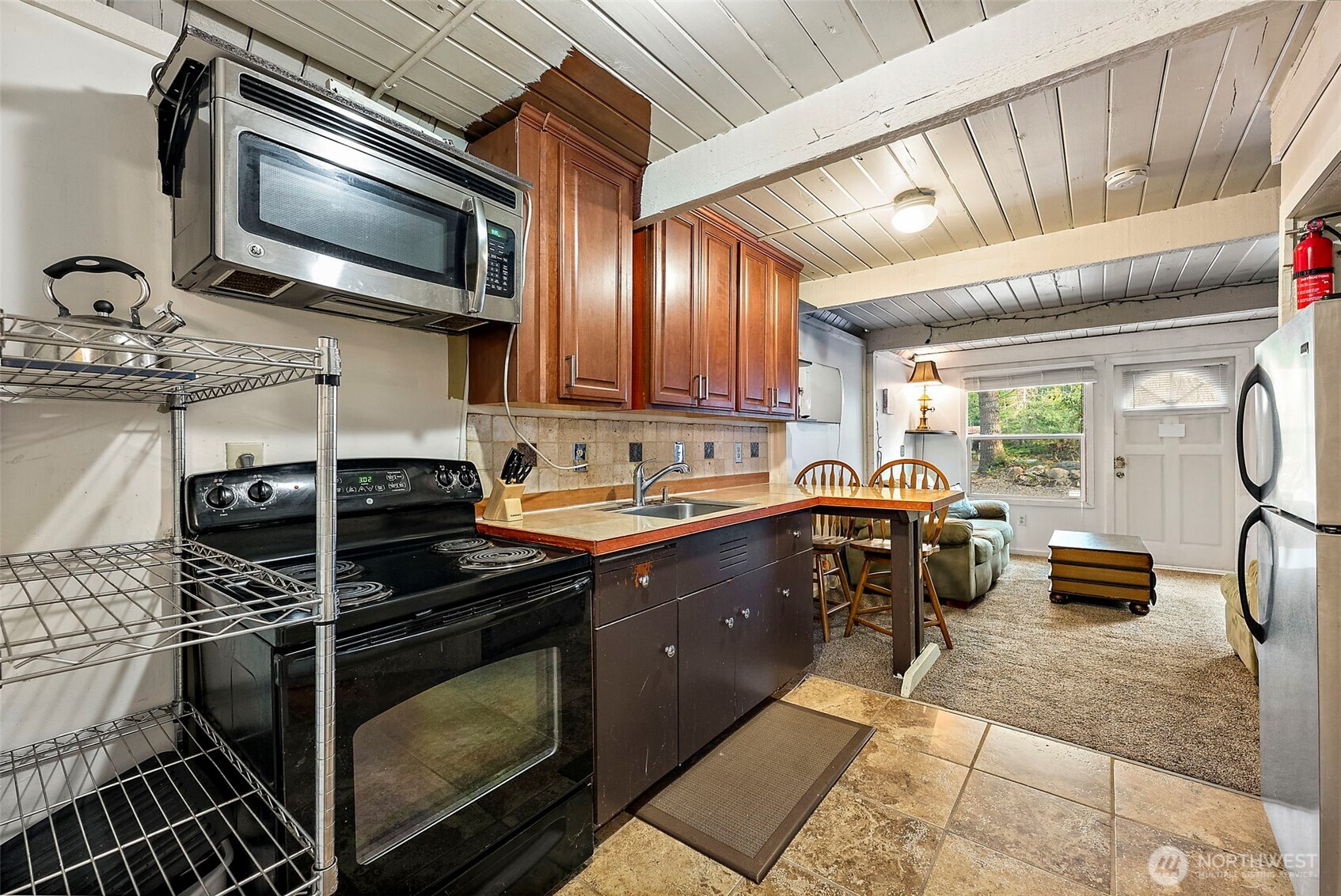 270 Skate Creek Road North Ashford, WA 98304 - Photo 9 of 36 a kitchen with kitchen island granite countertop a sink stove and microwave