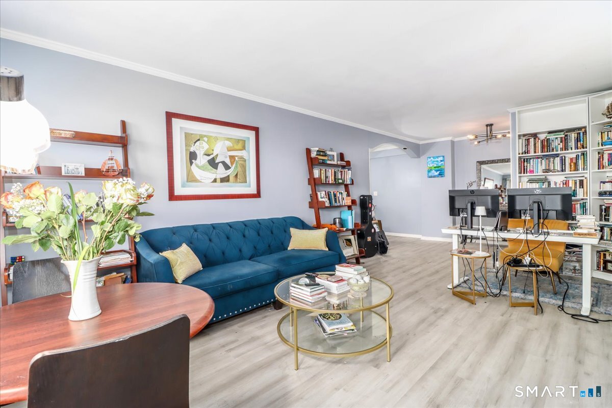 a living room with furniture and wooden floor