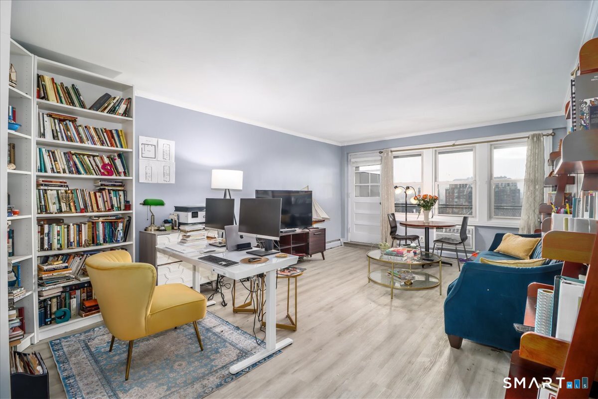 30 Glenbrook Road, Unit 10F Stamford, CT 06902 - Photo 2 of 30 a view of a livingroom with workspace and a couch