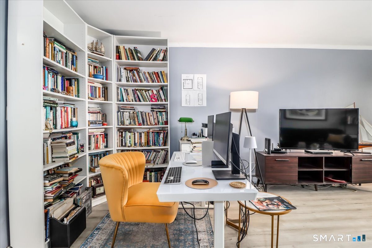 30 Glenbrook Road, Unit 10F Stamford, CT 06902 - Photo 5 of 30 a view of a livingroom with furniture and a flat screen tv