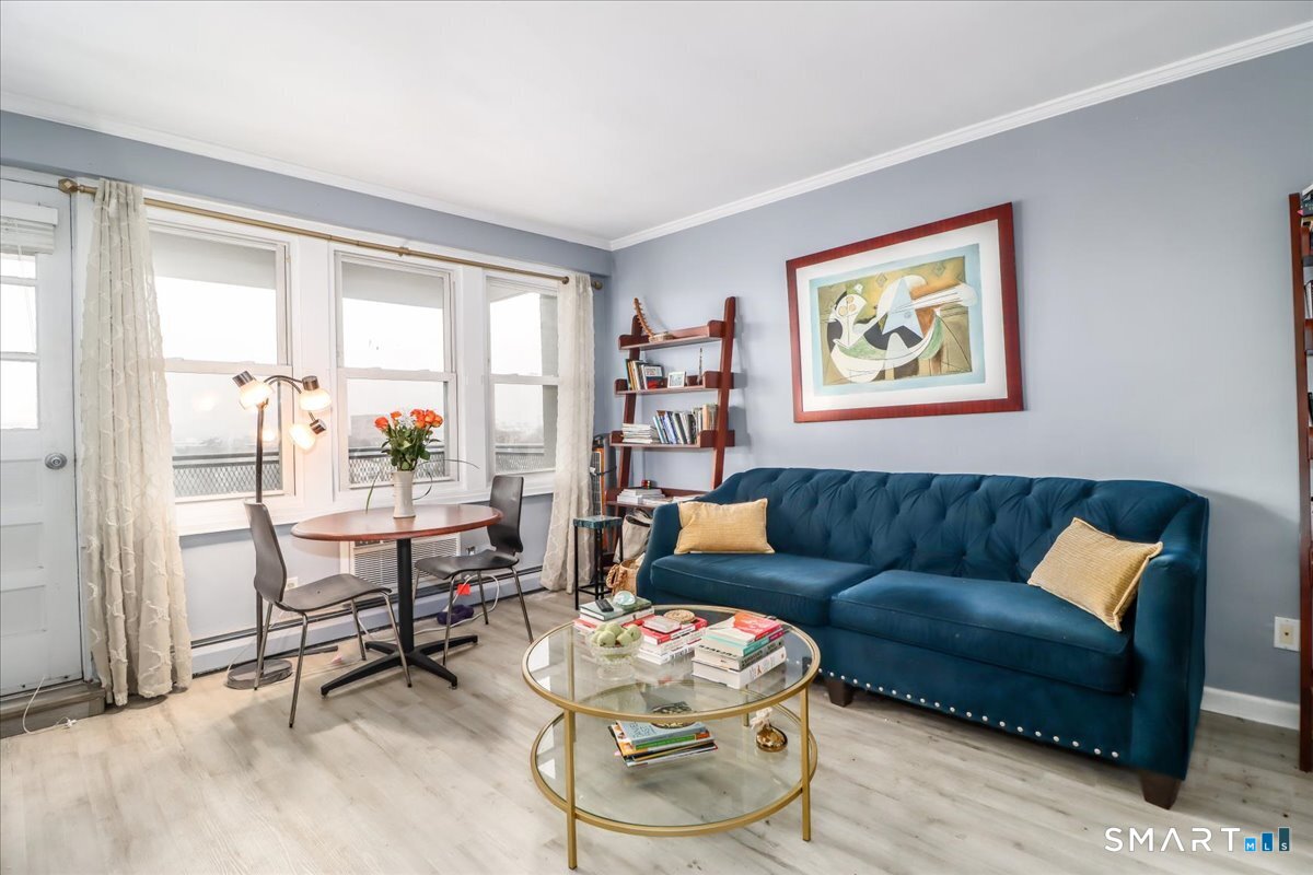 30 Glenbrook Road, Unit 10F Stamford, CT 06902 - Photo 6 of 30 a living room with furniture and a window