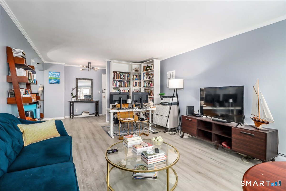 30 Glenbrook Road, Unit 10F Stamford, CT 06902 - Photo 7 of 30 a living room with furniture and a flat screen tv