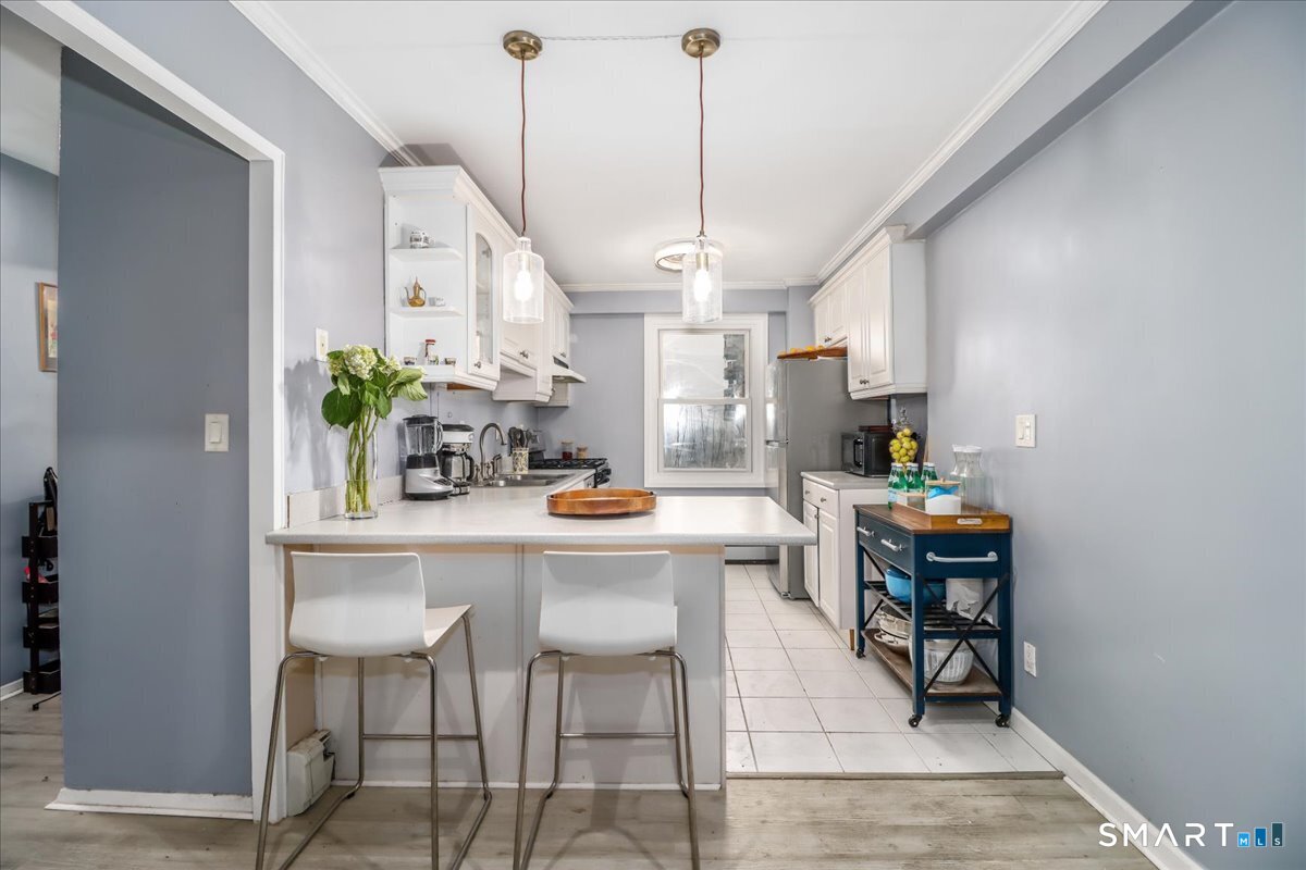 30 Glenbrook Road, Unit 10F Stamford, CT 06902 - Photo 9 of 30 a kitchen with a table and chairs in it