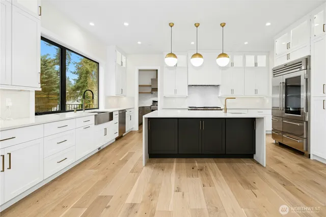 wooden floor in an empty room with white cabinet and a window