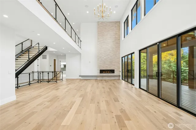 a view of empty room with wooden floor and stairs