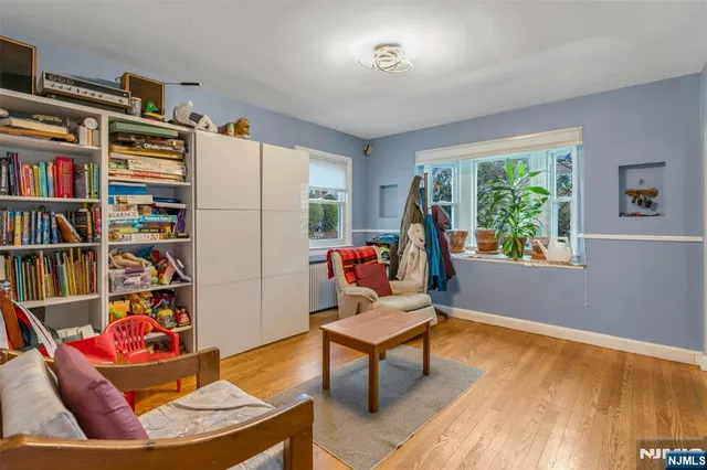 a living room with furniture and a book shelf