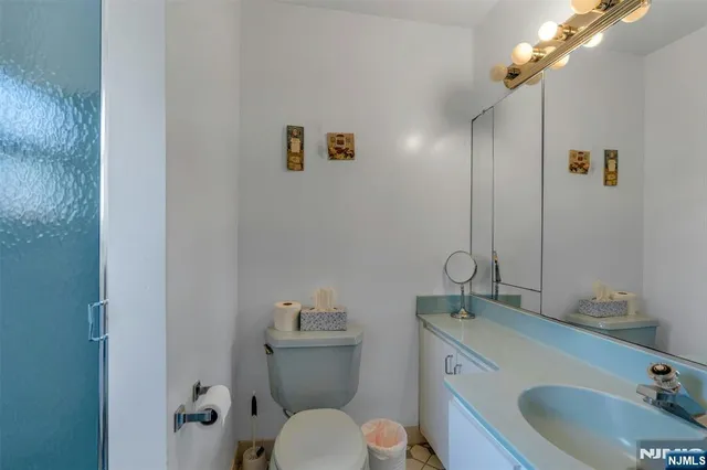 a bathroom with a toilet sink and mirror