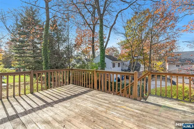 a view of balcony with wooden floor and fence