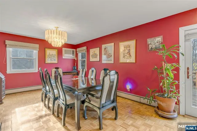 a view of a dining room with furniture and chandelier