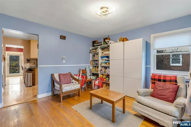 a living room with furniture a rug and a window