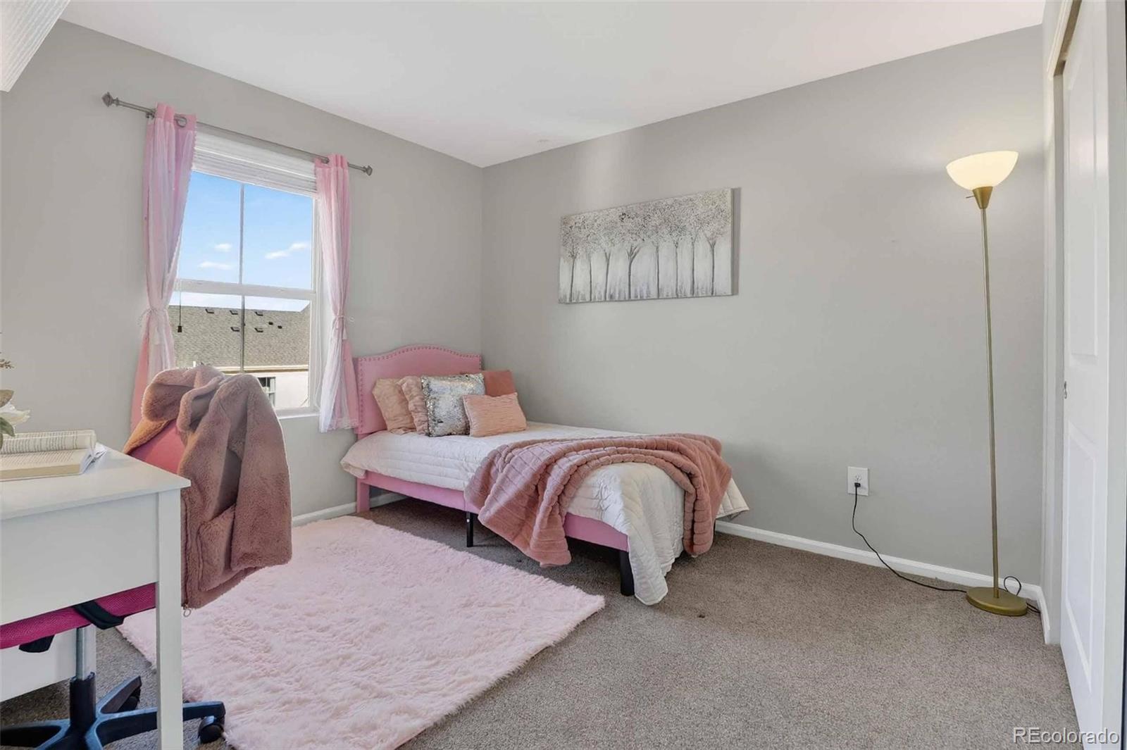10204 RidgeGate Circle Lone Tree, CO 80124 - Photo 7 of 11 a bedroom with a bed and a window