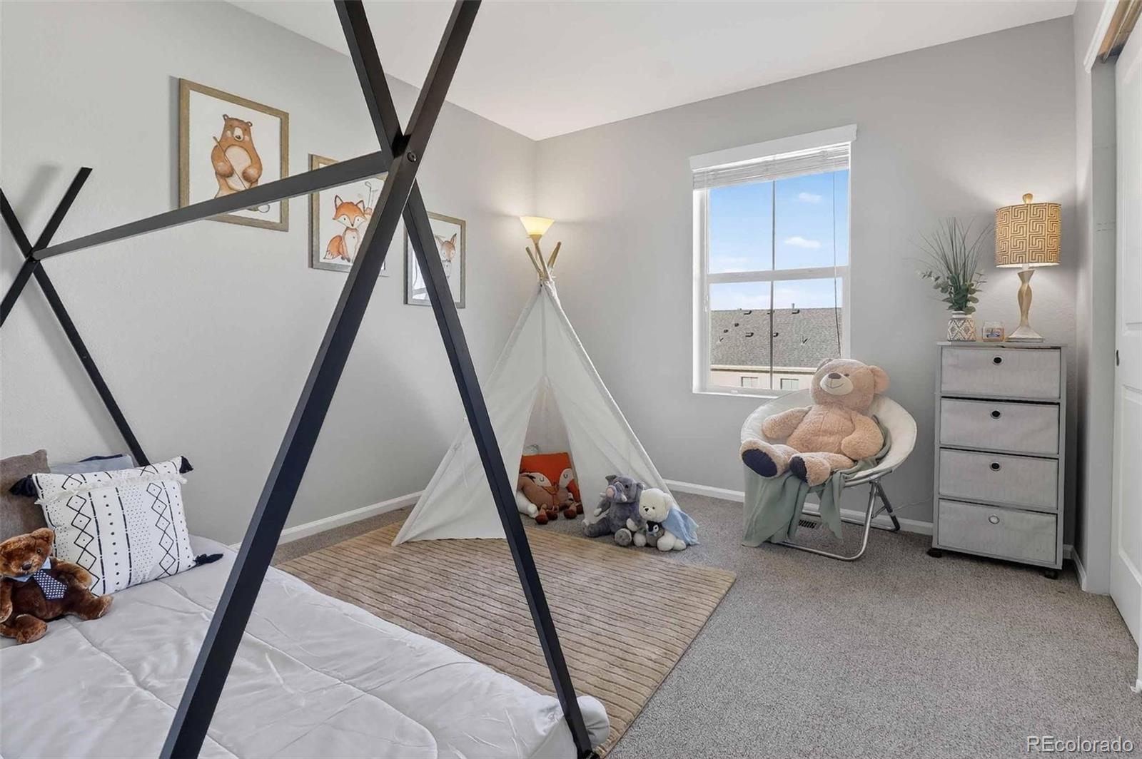 10204 RidgeGate Circle Lone Tree, CO 80124 - Photo 8 of 11 a bedroom with furniture and a window