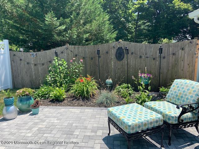 72 Rumson Road Little Silver, NJ 07739 - Photo 23 of 27 a wooden bench sitting in backside of a house with potted plants